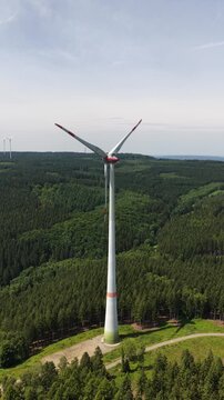 Wind Power, renewable resource, three blades in wind farm srtting. the foundation, the tower, the rotor and hub.