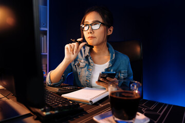 Creating young beautiful Asian creative woman thinking of sales target report on business market...