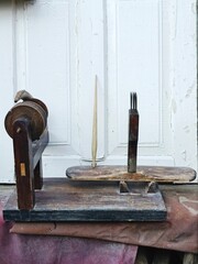 old wood spinning wheel found in the barn . High quality photo