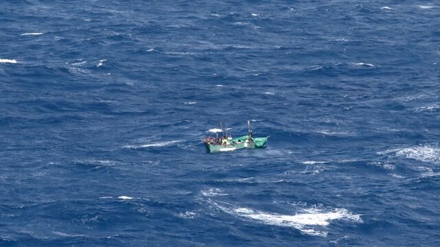 Cuban refugees ride on a small make shift boat on the Caribbean Sea