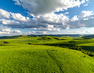 Fototapeta premium Rolling Hills with Green Pasture, and Sunny Sky.