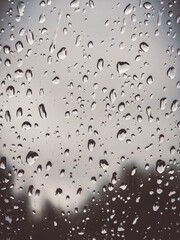 Simple photo of water droplets on light glass surface – clean lines and neutral tones.