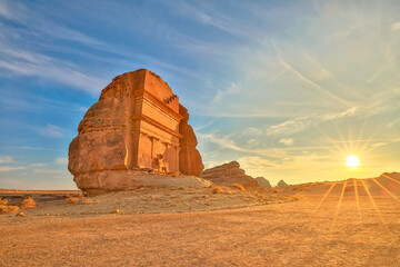 The majestic Qasr Al Farid, also known as the tomb of Lihyan son of Kuza, stands tall in the Hegra desert of AlUla, Saudi Arabia, bathed in the warm glow of the setting sun