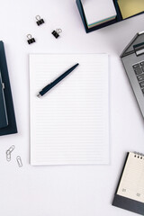 Top view of office table with laptop, pen, nootbook and stationery in home office room, clipping path. Desktop mock up.