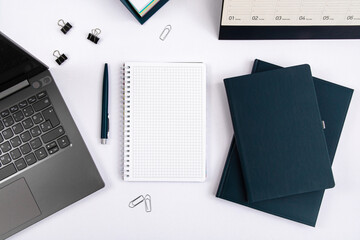 Top view of office table with laptop, pen, nootbook and stationery in home office room, clipping path. Desktop mock up.
