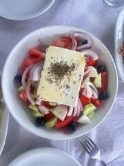 Greek salad of fresh cucumber, tomato, sweet pepper, red onion, feta cheese and olives with olive oil. Healthy food. Top view