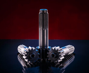 Three polished metal shafts stand on a dark surface