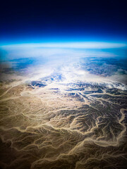 Bright ridges cross an expansive desert landscape.