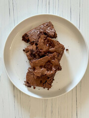 chocolate chip brownies on a white plate. 