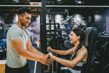 Adult sports woman doing chest press exercise with personal trainer