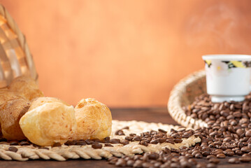 Cheese bread and coffee, delicious Brazilian cheese bread and a beautiful cup of coffee on a rustic...
