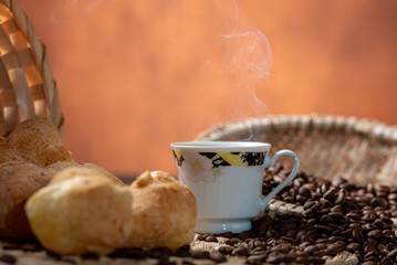 Cheese bread and coffee, delicious Brazilian cheese bread and a beautiful cup of coffee on a rustic...