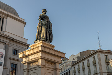 Fototapeta premium Madrid, Spain. Monument to Queen Isabel II in Plaza de Isabel II, in front of the Royal Theatre. Sculpted by Jose Piquer Duart in 1850, it honors the monarch who inaugurated the opera house