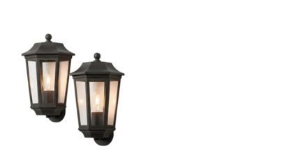 Two dark metal outdoor wall mount lanterns with clear glass panes and warm glowing bulbs are mounted
