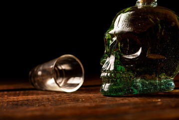 Cachaça, Brazilian cachaça bottle in the shape of a skull and a glass, on rustic wood and...