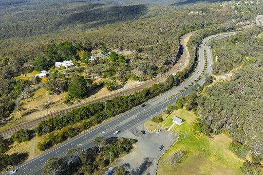 Drone aerial photograph of the Great Western Highway and nearby Railway Line adjacent to Bulls Camp Reserve near Woodford in the Blue Mountains, NSW, Australia.