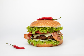 Hamburger with bacon and chili on white background