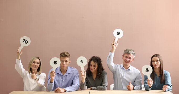 Panel of emotional judges voting with score signs at tables against beige background