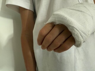 Injured arm wrapped in white bandage after accident or medical treatment