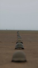 Row of Military Boots on a Dusty Training Ground