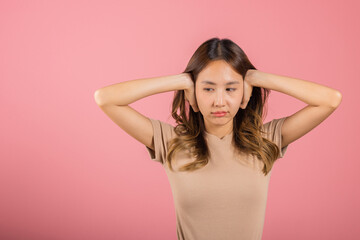 Asian portrait beautiful young woman have close ears with hand palms and close eyes, studio shot...