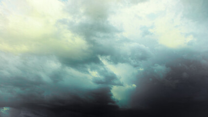 Dark gray thunderstorm clouds loom before a strong storm, bringing bad inclement weather
