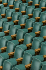 Obraz premium Rows of auditorium chairs ready for the audience, symbolizing the anticipation of a show or performance. Perfect for corporate events, pantone transformative teal color.