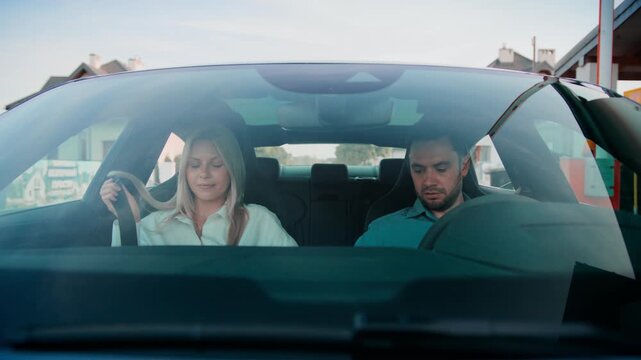 Tired blonde woman leaning toward door preparing to exit car after ride. Bearded man in blue shirt looking down while switching off engine. Wrapping up journey. Leaving after long drive.