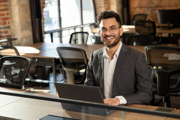 Handsome young manager working in the office and looking confident