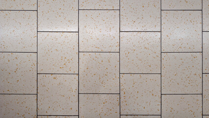 Naklejka premium Top view of modern floor texture with square intercalated off-white or light beige semi-gloss porcelain stoneware tiles terrazzo imitation with ochre-toned aggregates. Indoor and outdoor surface. 