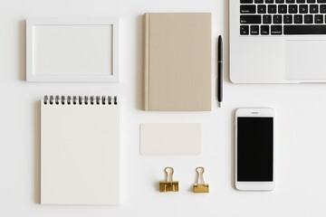 Minimalist work desk setup featuring a modern laptop, sleek smartphone, stylish notebook, and elegant stationery creating an organized workspace promoting productivity and creativity