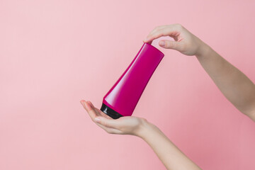 Cosmetic unbranded bottle for shampoo, mask, lotion with pink background. Concept of beauty. Product cosmetic advertising