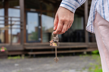 Woman with keys in hand to new house. Moving relocation, mortgage, property, real estate concept. Buying or renting