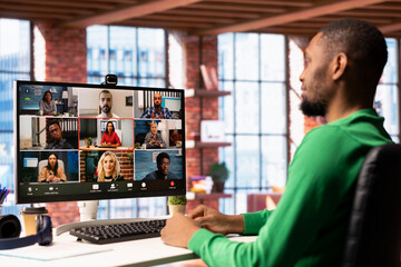 Remote employee discussing with coworkers during videocall from home, organizing calendar...