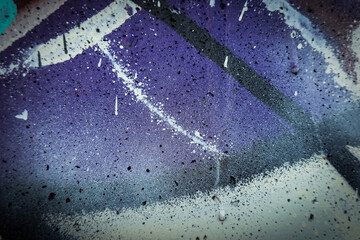 Messy grunge purple wall background with random white, black paint strokes and drops