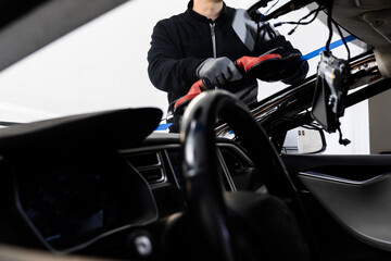 Windshield Installation Using Suction Lifters. Two technicians install windshield using suction...