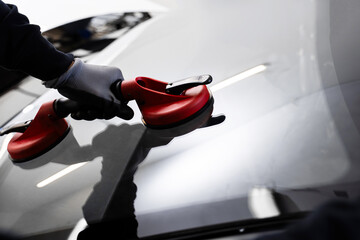 New Windshield installation process. Windshield Installation Using Suction Lifters. Two technicians...