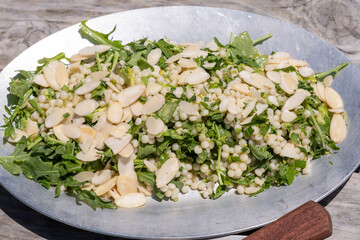 Chopped chicken breast served over a bed of shredded lettuce and fresh herbs with a lemony dressing