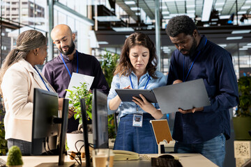 Ambitious work team collaborates on a financial planning project in an office, emphasizing teamwork...