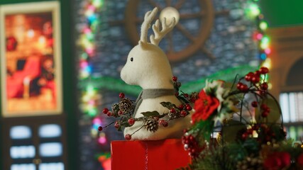 Close up of Christmas ornaments in room with presents, stockings, fireplace and other holiday...