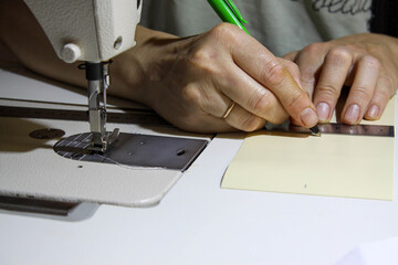 Seamstress' work. Marking the material. Cutting