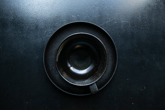 black cup on black windowsill, top view