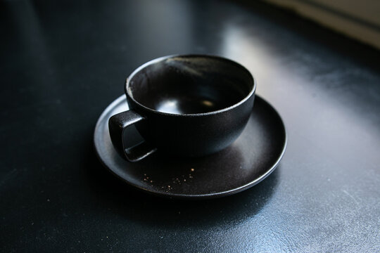 black cup on a black windowsill