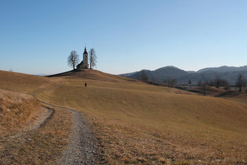 Woman Walking towards Saint Thomas Church, Slovenia