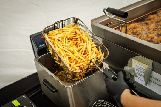 French fries being removed from deep fryer