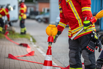 Firefighter places warning light during emergency operation