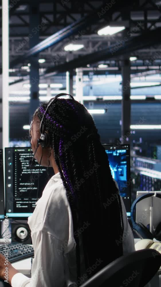 Poster vertical video admin in data center wearing headset assisting users with artificial intelligence tro