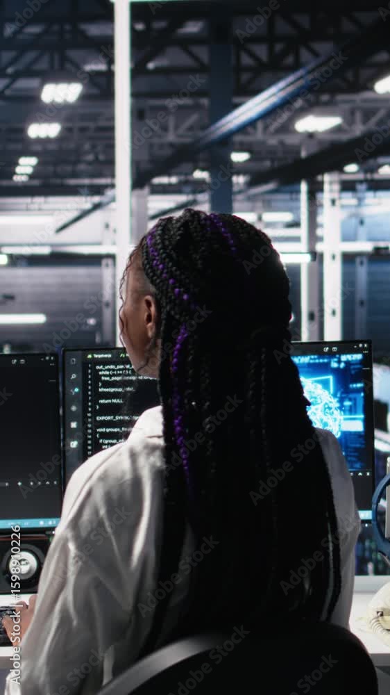 Poster vertical video female programmer in data center reviews ai diagnostics, analyzing neural network per