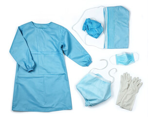 Medical protective gear set including light blue surgical gown, cap, face mask, gloves. Essential sterile attire for healthcare professionals ensuring safety, hygiene in hospitals during procedures.