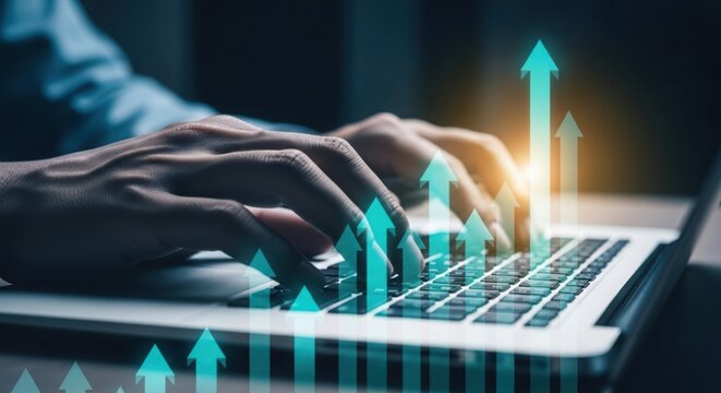 Close up of hands typing on a laptop with upward trending green arrows symbolizing financial growth and success